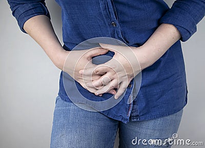 A woman suffers from pain in the appendix. Acute appendicitis, Crohn`s disease, or inflammatory bowel disease. Surgeon examination Stock Photo