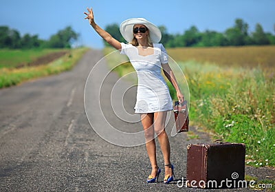 Woman with suitcase stops the car Stock Photo