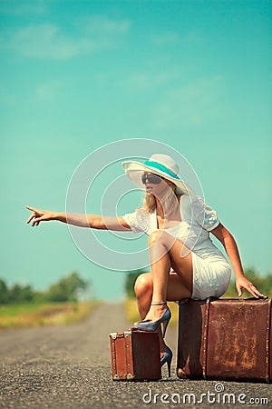 Woman with suitcase stops the car Stock Photo