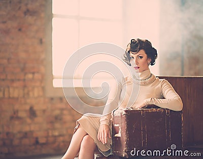 Woman with suitcase on a train station Stock Photo