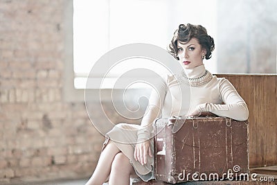 Woman with suitcase on a train station Stock Photo