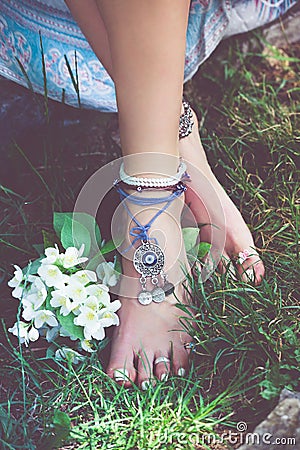 Woman summer boho fashion style details on barefoot anklets and Stock Photo