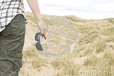 Woman with sun glasses in sand dunes landscape Stock Photo