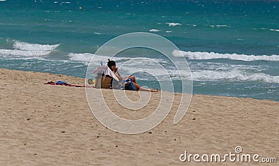A woman sunbathe in El Arenal beach in Mallorca wide Editorial Stock Photo
