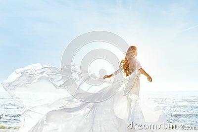 Woman on Sunny Sea Beach in White Fluttering Dress, Fashion Model Back Rear View, Silk Cloth Waving on Wind Stock Photo