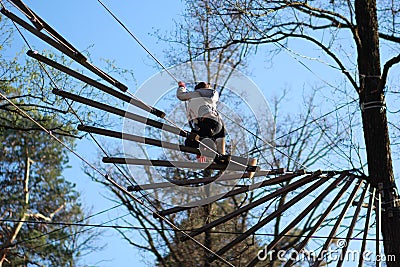 Woman surmountain obstacles in the rope park Stock Photo