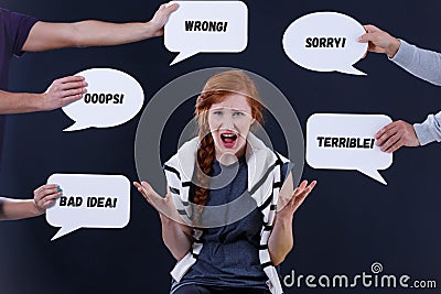 Woman surrounded by comments in speech bubbles Stock Photo