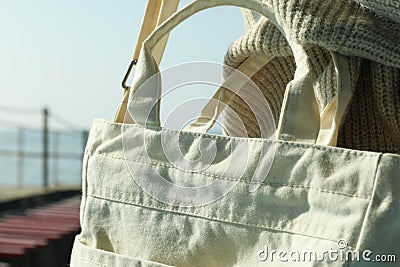 Woman in sweater hold stylish eco bag, close up Stock Photo