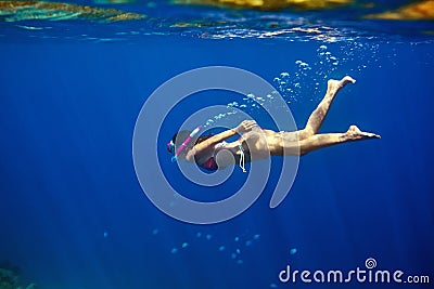 Woman swim underwater in tropical sea with mask Stock Photo
