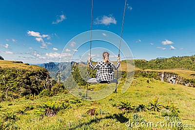 Hiker woman on a swing in Canyon park in Santa Catarina, Brazil Stock Photo