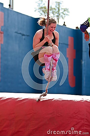 Woman Swings Rope Across Obstacle In Crazy 5K Race Editorial Stock Photo