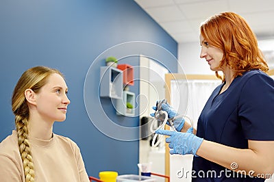 A woman with symptoms of dizziness is seen by a neurologist. The doctor explains to the patient about the structure of the inner Stock Photo
