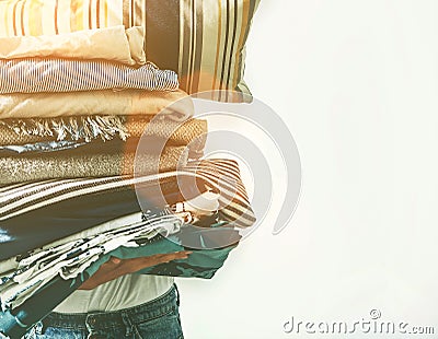 Woman take in hands big pile home textile for ironing Stock Photo