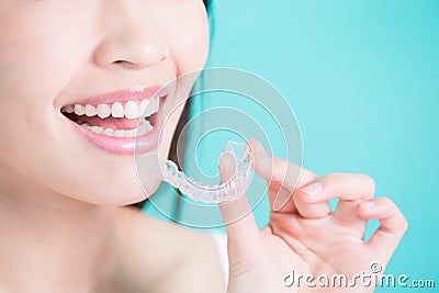 Woman take invisible braces Stock Photo