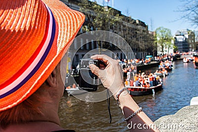 Woman takes photo of party - Koninginnedag 2012 Editorial Stock Photo