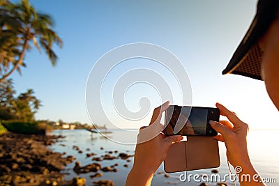 Woman takes picture of two surfers Stock Photo