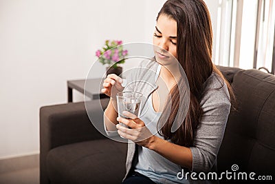 Woman taking antacid Stock Photo