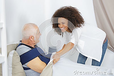 Woman taking care elderly man in nursing home Stock Photo