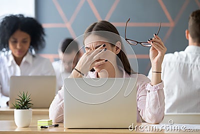 Woman taking off glasses tired of work, eyes fatigue concept Stock Photo