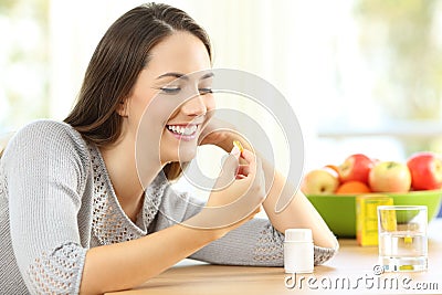 Woman taking omega 3 vitamin pills Stock Photo