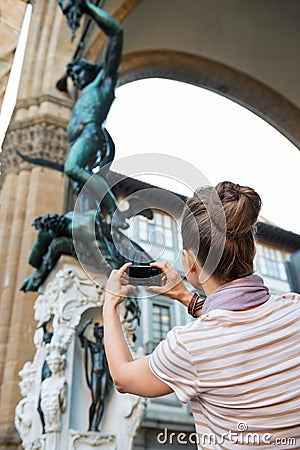 Woman taking photo of statue perseus in florence Stock Photo