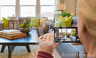 Woman Taking Photos of A Living Room in Model Home with Her Smart Phone Stock Photo