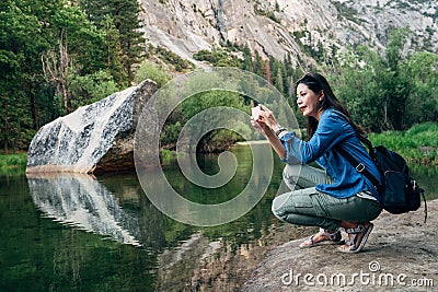 Woman taking picture of amazing nature view Stock Photo