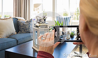 Woman Taking Pictures of A Living Room in Model Home with Her Smart Phone Stock Photo