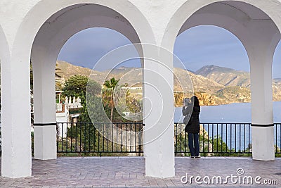 Woman taking pictures with tablet at Balcony Of Europe Editorial Stock Photo