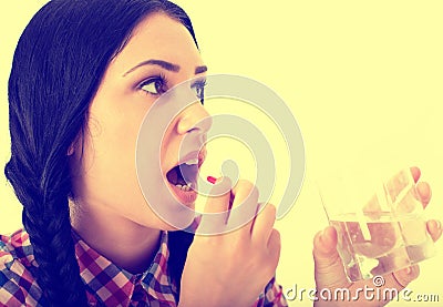 Woman taking pill Stock Photo