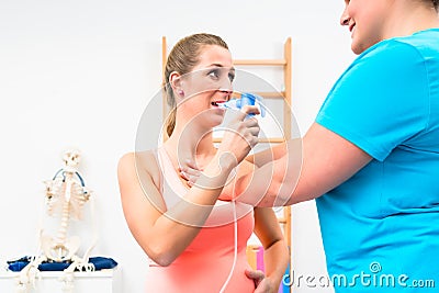 Woman taking pulmonary function test with mouthpiece in her hand Stock Photo