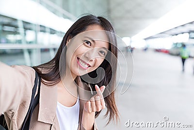 Woman taking selfie with korean style heart finger gesture Stock Photo