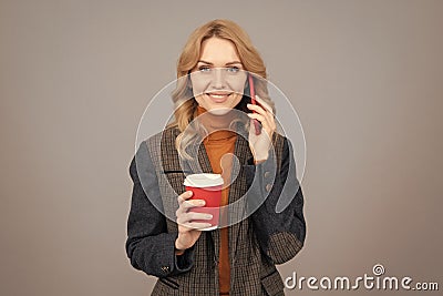 Woman talk on phone drinking coffee. Caffeine and smartphone addiction. Addiction to technology Stock Photo