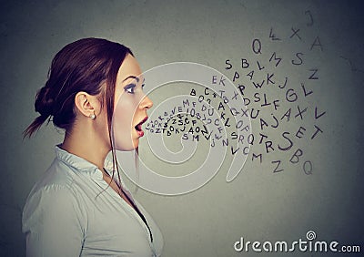 Woman talking alphabet letters coming out of mouth Stock Photo