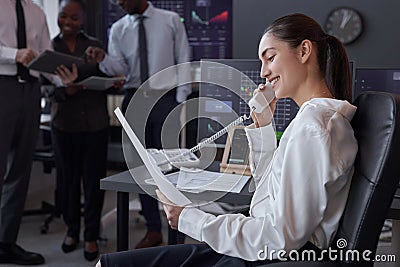 Woman talking on the phone in broking office Stock Photo