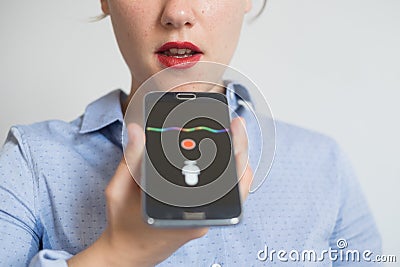 Woman talking on the phone with digital voice assistant Stock Photo