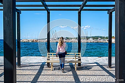 A woman talking on the phone, pier, Nikiti, Greece Editorial Stock Photo