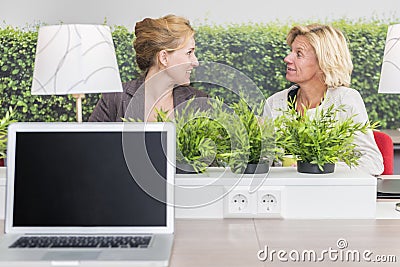 Woman talking in their workarea Stock Photo