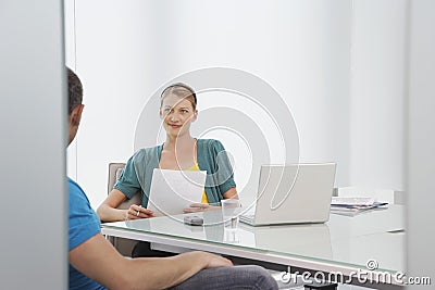 Woman Talking To Cropped Colleague In Office Stock Photo