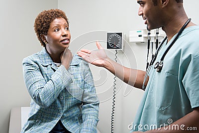 Woman talking to doctor Stock Photo