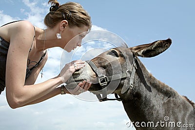 Woman talking to donkey Stock Photo