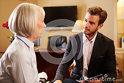 Woman Talking To Male Counsellor Using Digital Tab Stock Photo