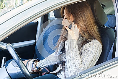 Woman talking to mobile phone and searching purse Stock Photo