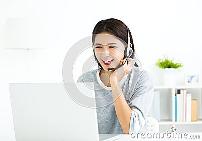 woman talking in video call on line with headsets and laptop Stock Photo