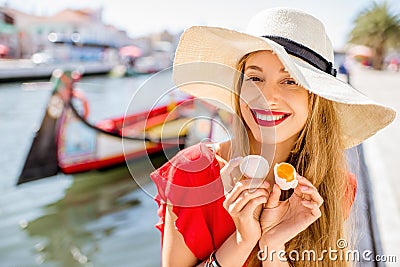 Woman tasting portuguese dessert in Aveiro city Stock Photo
