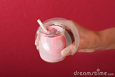 Woman with tasty raspberry smoothie on red, closeup Stock Photo