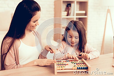 Girl and Woman with Educational Game on Table. Stock Photo