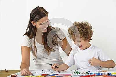 Woman teaches her child how to draw Stock Photo