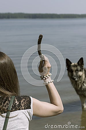 Woman Teasing A Dog Stock Photo