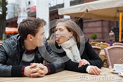 Woman Teasing Man While Sitting Restaurant Stock Photo